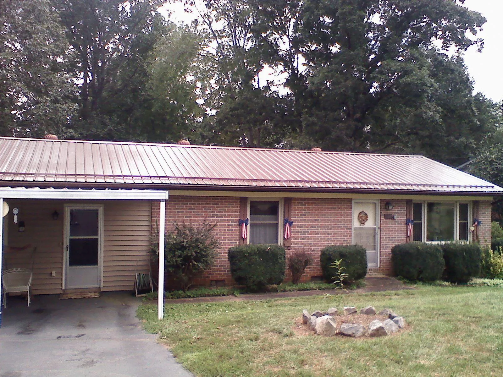 Bronze metal roof and carport on a brick ranch home — Roof Repair work by our crew in Alverton