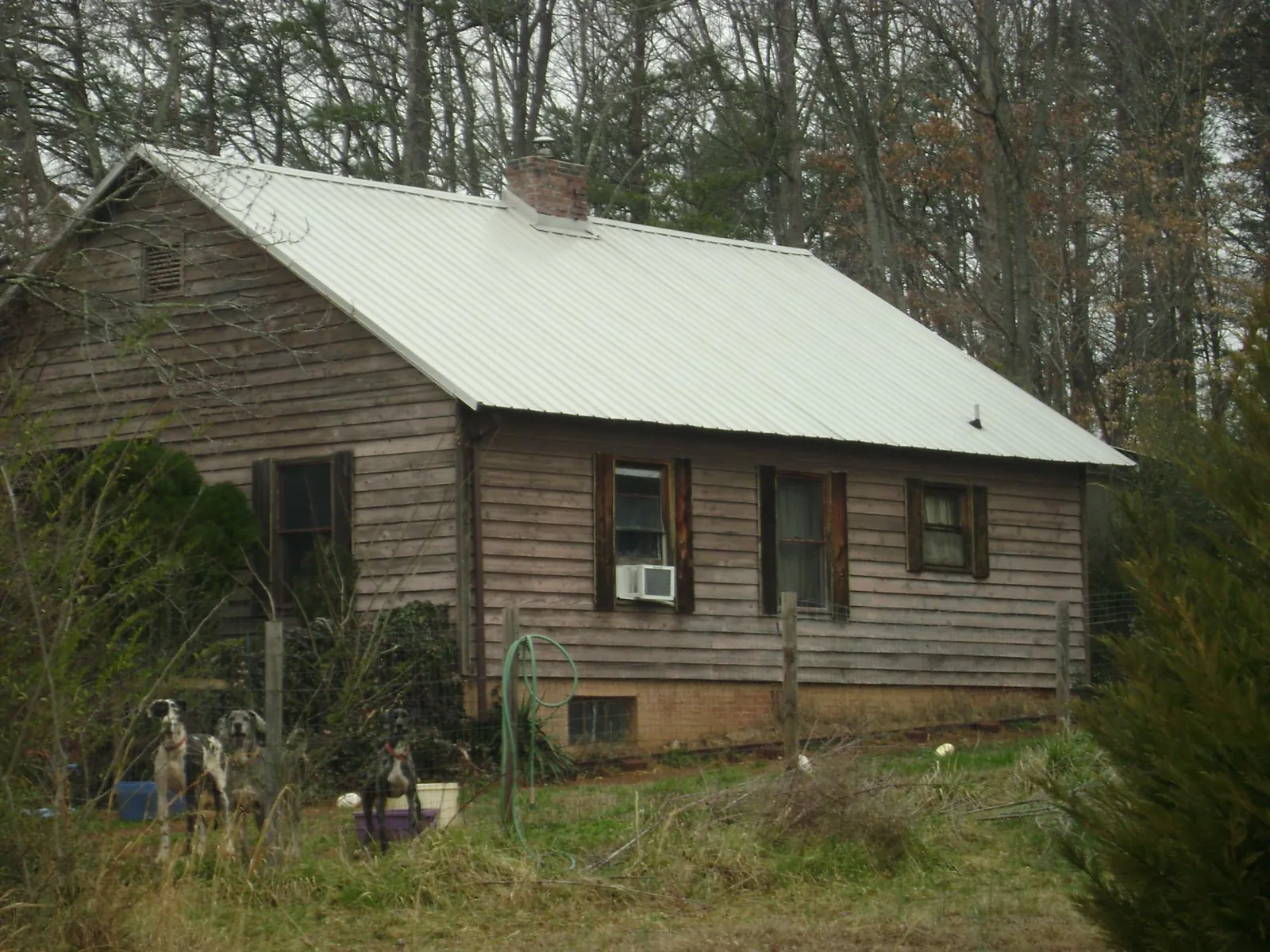 White metal roof on an old wood sided farmhouse, from a Metal Roof Installation job in Alverton
